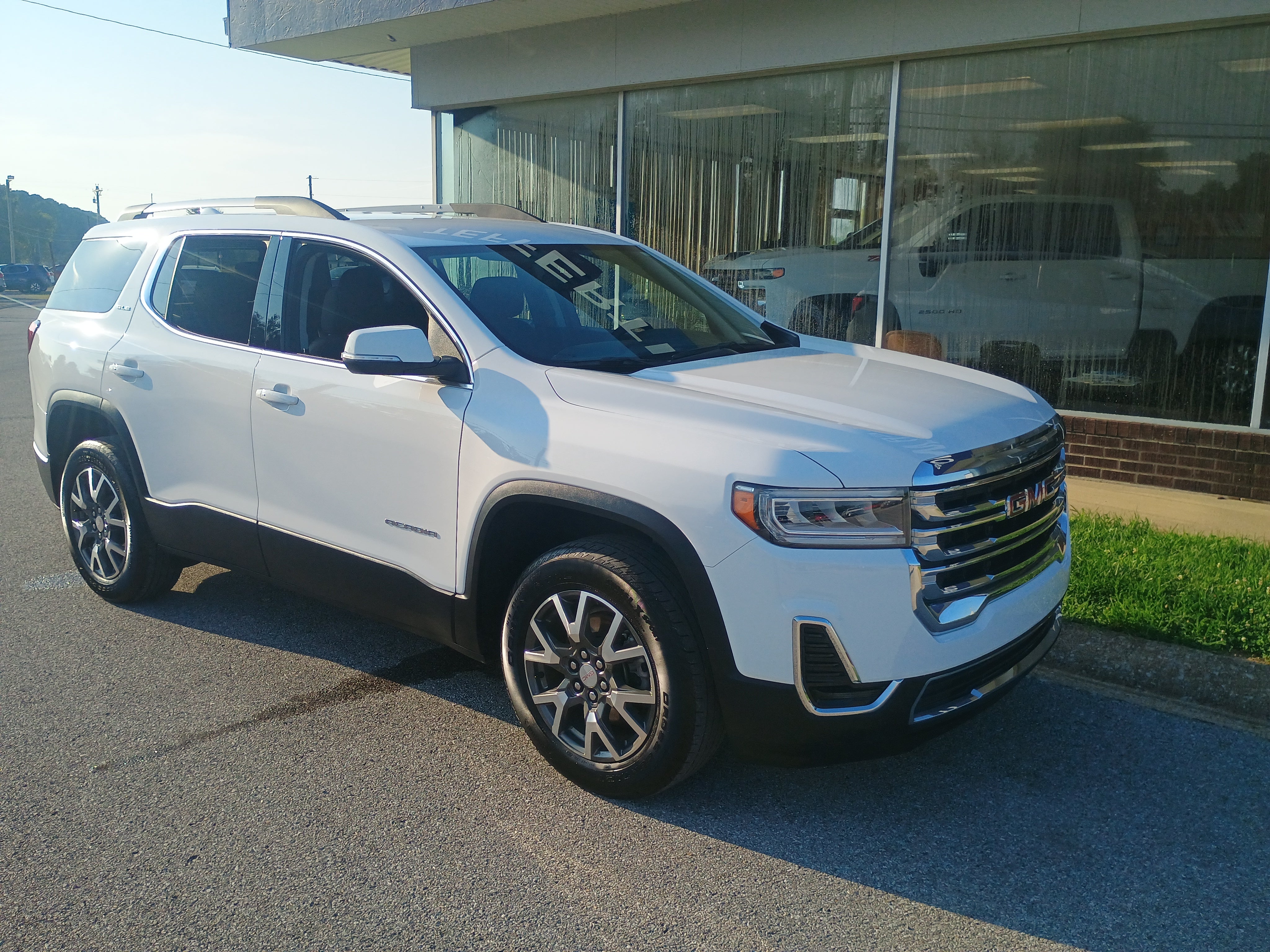 2023 GMC Acadia SLE in Summit White — front three-quarter view