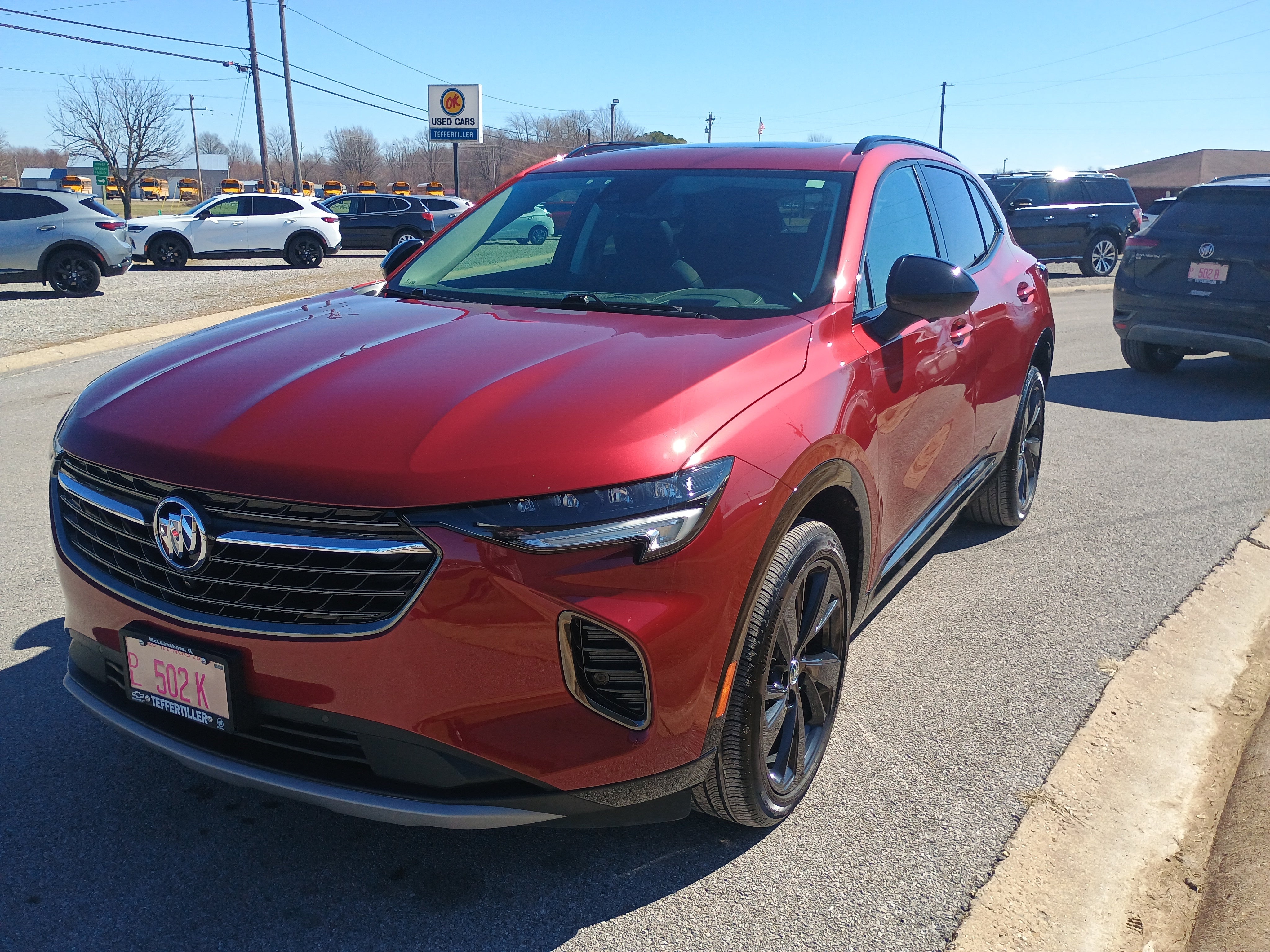 2023 Buick Envision Essence in Cinnabar Metallic — front three-quarter view